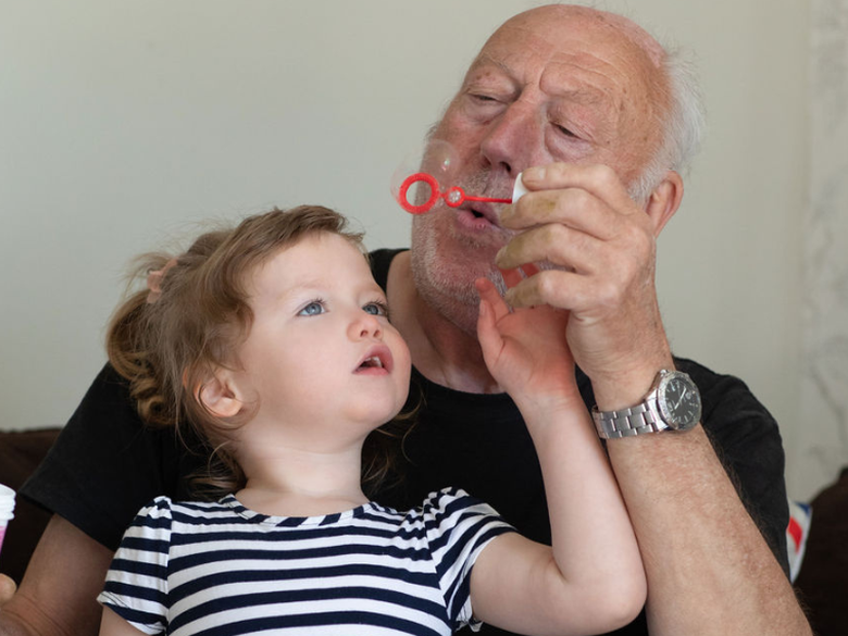 Josie-Mae and Grandad with bubbles