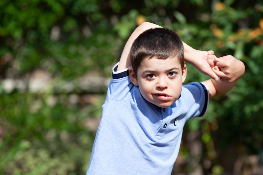 Jacob's story - picture of Jacob standing outside with his arms above his head
