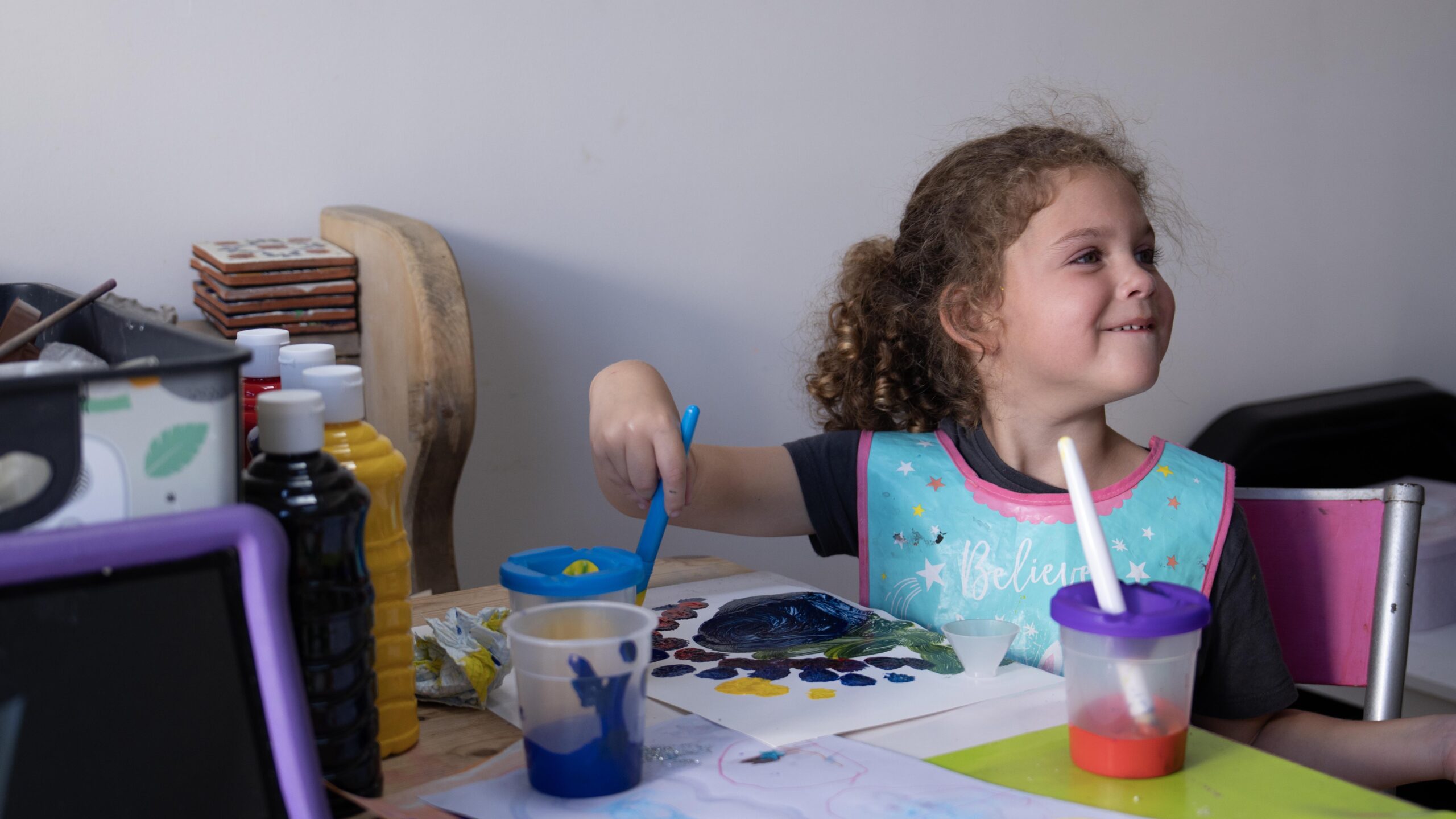 Etta painting at a table