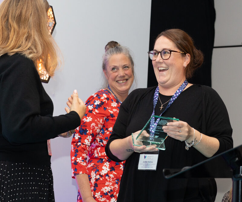 Jackie Harlow receiving her award from Galia Wilson, Chair of Trustees
